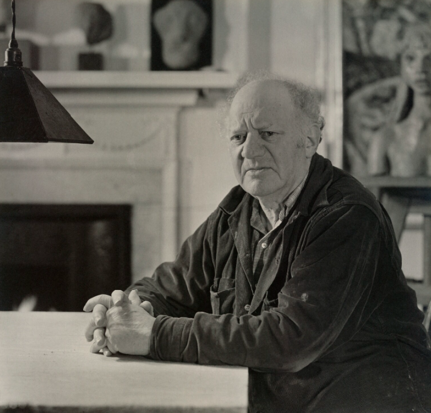 Portrait of Jacob Epstein, Geoffrey Ireland. Ancient Egyptian items from Epstein’s collection can be seen on the mantlepiece behind him.